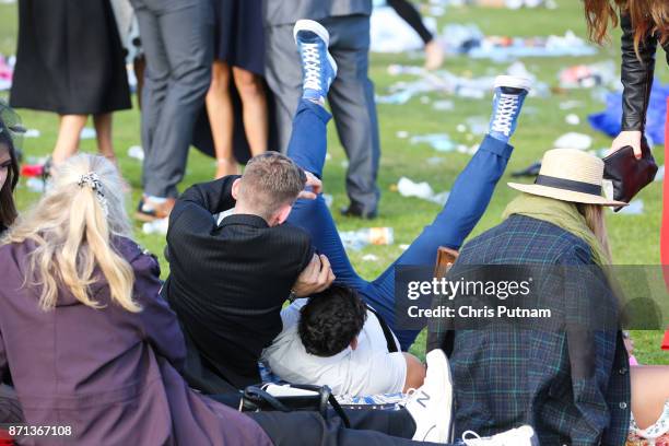 Drunk punters wrestle at the end of the day arrive at the Melbourne Cup Carnival on November 7, 2017 in Melbourne, Australia. PHOTOGRAPH BY Chris...