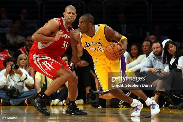 Kobe Bryant of the Los Angeles Lakers drives on Shane Battier of the Houston Rockets in the third quarter of Game Five of the Western Conference...