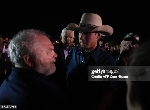 Stephen Willeford and Johnnie Langendorff, who both chased after suspected killer Devin Kelley, meet again during a vigil in Sutherland Springs,...