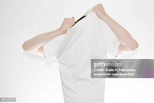 undressing white t-shirt - entkleiden stock-fotos und bilder