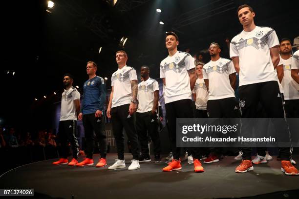 Members of the German national football team gather on the stage at the presentation of the 2018 FIFA World Cup Russia Adidas jersey at The Base on...