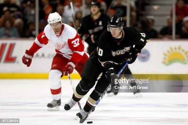 Corey Perry of the Anaheim Ducks moves the puck against Mikael Samuelsson of the Detroit Red Wings during Game Six of the Western Conference...
