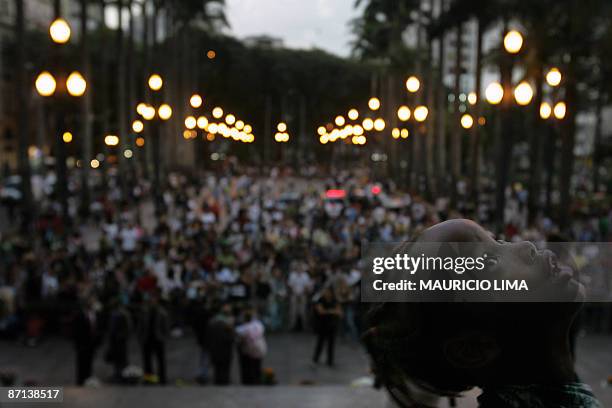 An Afro-Brazilian boy looks at the sky during a demonstration against discrimination of Afro-Brazilian models on fashion shows, at the main entrance...