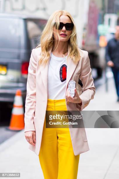 Kate Bosworth is seen wearing Oscar de la Renta with Prada shoes, Anito Ko earrings, Kat Kim ring and an Edie Parker handbag in Midtown on November...