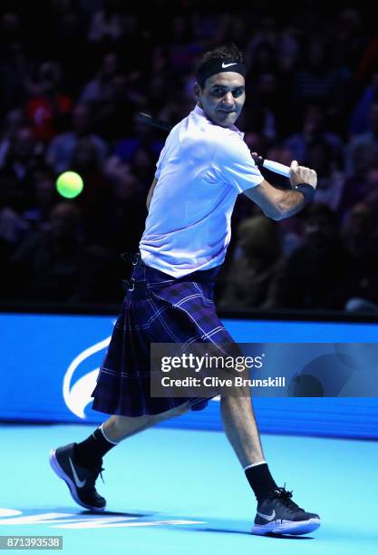 Roger Federer plays a shot whilst wearing a kilt during his match against Andy Murray during Andy Murray Live at The Hydro on November 7, 2017 in...