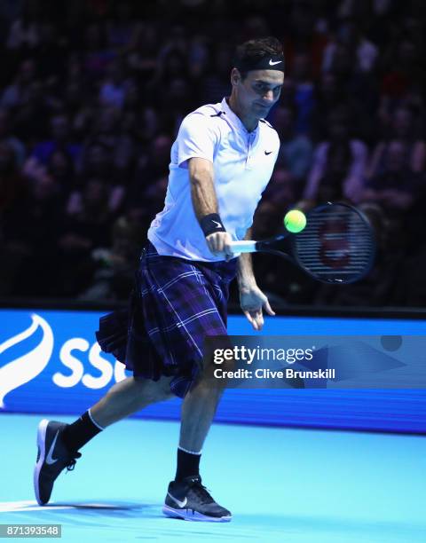 Roger Federer plays a shot whilst wearing a kilt during his match against Andy Murray during Andy Murray Live at The Hydro on November 7, 2017 in...