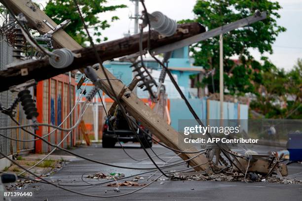 Power line poles downed by the passing of Hurricane Maria lie on a street in San Juan, Puerto Rico on November 7, 2017. The Center for Puerto Rican...