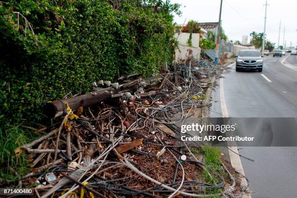 Power line poles and lines downed by the passing of Hurricane Maria lie on a sidewalk in San Juan, Puerto Rico on November 7, 2017. The Center for...