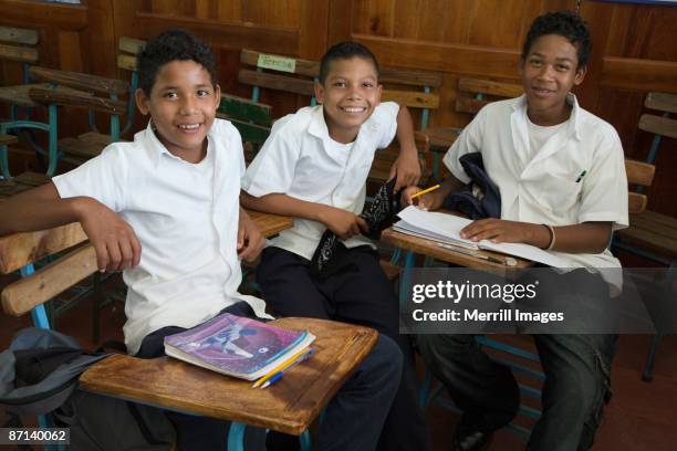 3 boys sitting in classroom - nicaragua fotografías e imágenes de stock