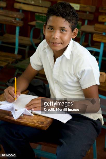 young boy sitting in classroom  - nicaragua fotografías e imágenes de stock