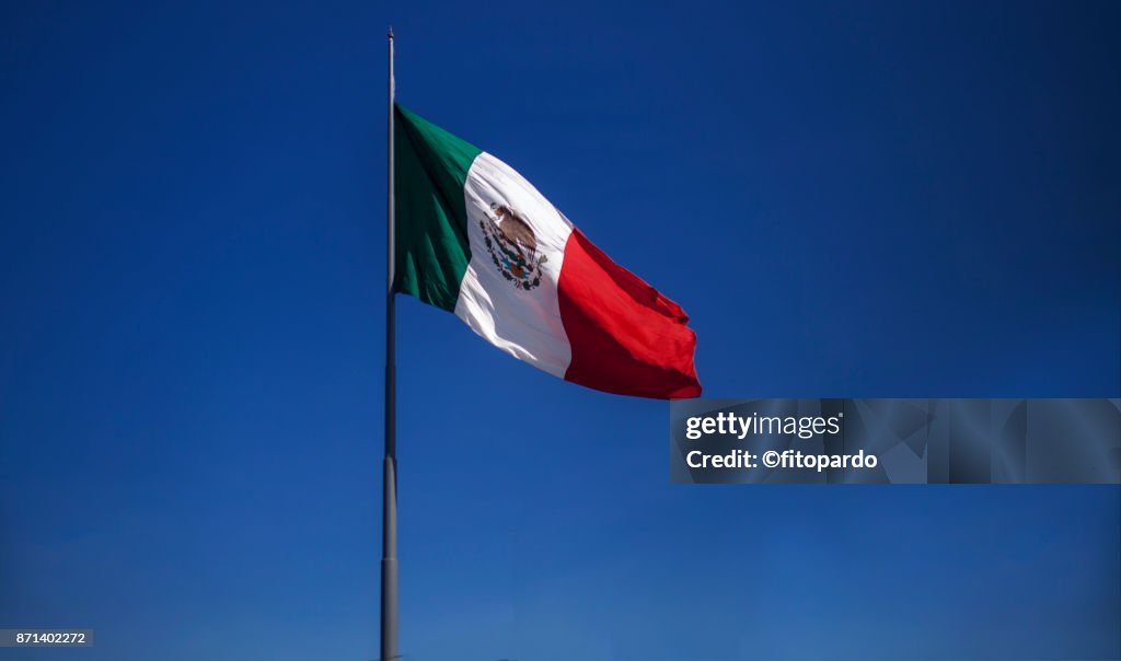 Mexican flag with blue sky