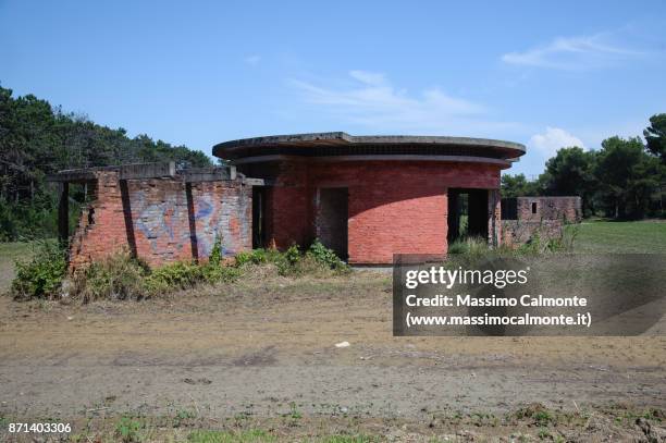 abandoned building structure surrounded by cultivated fields in summer. - bibione stock pictures, royalty-free photos & images
