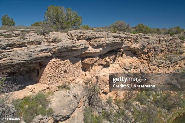 montezuma well with ancient dwellings built into side of rim. - sinagua stock pictures, royalty-free photos & images