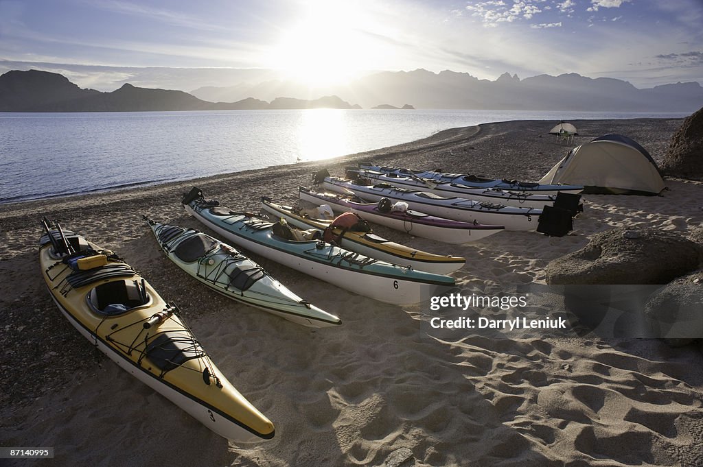 Kayaks and tent on beach