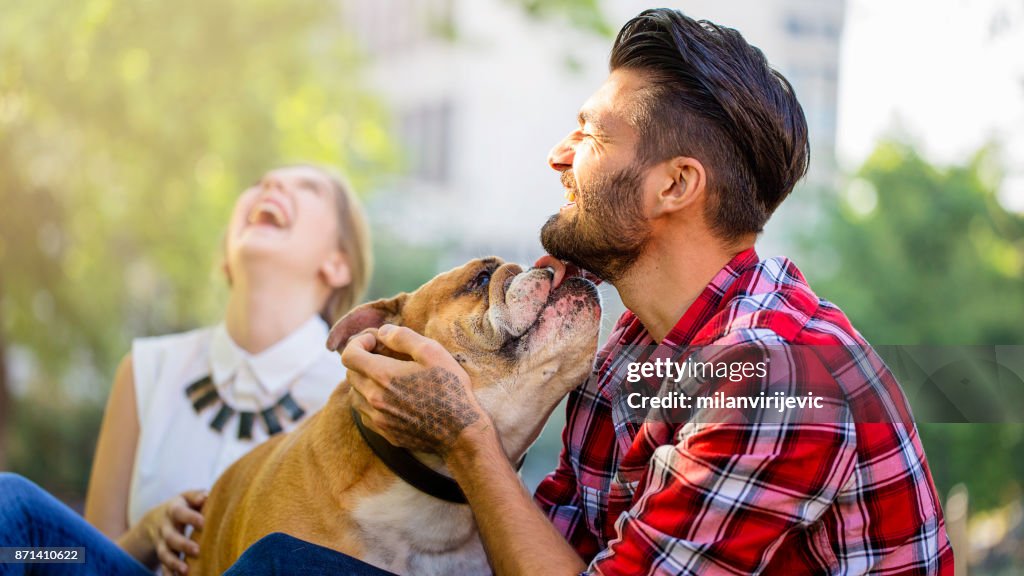 Young happy couple with dog