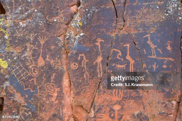 ancient petroglyphs carved into red rock at v-bar-v heritage site, sedona, arizona. - sinagua stock pictures, royalty-free photos & images