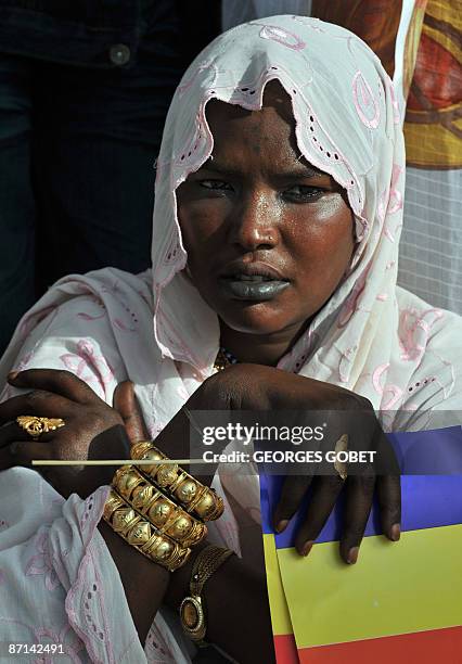 Supporter of Chadian President Idriss Deby Itno holds the national flag on May 13, 2009 in Ndjamena. Deby led around 10,000 anti-Sudanese...