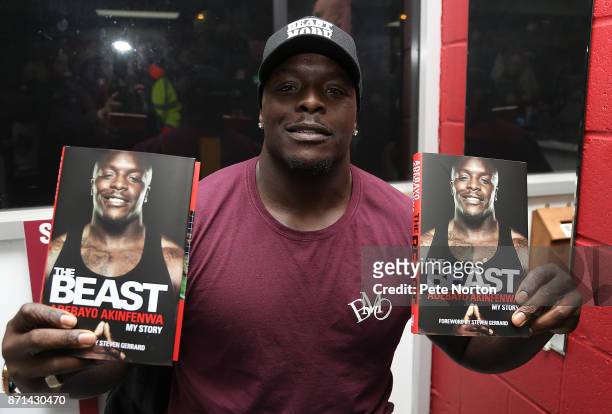Former Northampton Town player Adebayo Akinfenwa with copies of his book "The Beast" during a book signing at Sixfields on November 7, 2017 in...