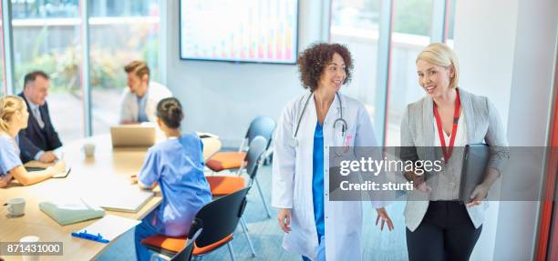 medical business relationship - nurse check board stock pictures, royalty-free photos & images