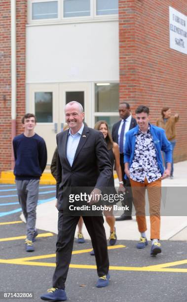 Democratic gubernatorial candidate Phil Murphy and his family leaves after voting on election day November 7, 2017 in Asbury Park, New Jersey. Murphy...