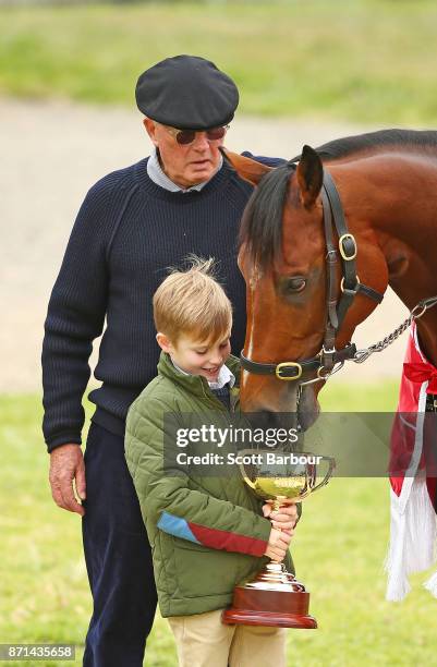 Melbourne Cup-winning part-owner Lloyd Williams and his grandson Frank Williams pose with Emirates Melbourne Cup winner Rekindling during the...