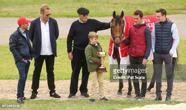 Melbourne Cup winner Rekindling is pictured with L-R jockey Corey Brown , Nic Williams , Lloyd Williams , Nic's son Frank Williams , strapper MJ...