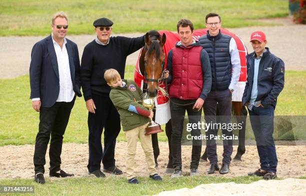 Melbourne Cup winner Rekindling is pictured with L-R jockey Corey Brown , Nic Williams , Lloyd Williams , Nic's son Frank Williams , strapper MJ...