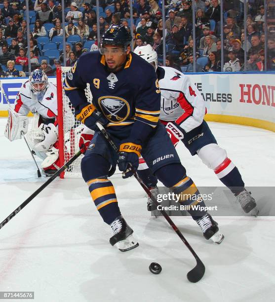 Evander Kane of the Buffalo Sabres controls the puck against Taylor Chorney of the Washington Capitals during an NHL game on November 7, 2017 at...