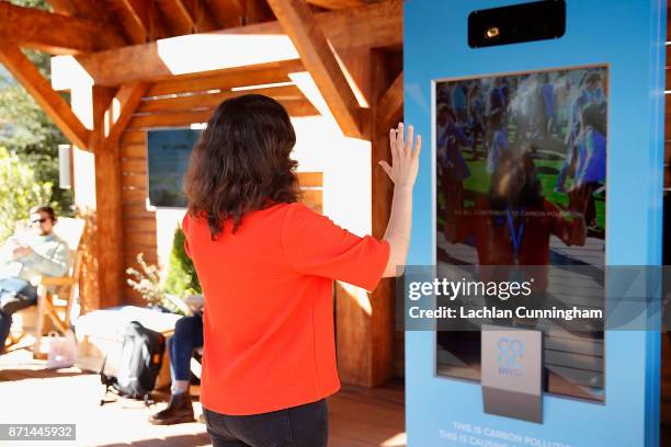 Marisa de Belloy, CEO of non-profit Cool Effect, engages with the Carbon Vision Mirror at Dreamforce on November 7, 2017 in San Francisco,...