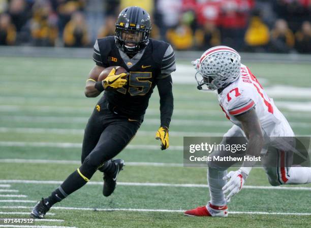 Running back Akrum Wadley of the Iowa Hawkeyes rushes up field during the third quarter against linebacker Jerome Baker of the Ohio State Buckeyes on...