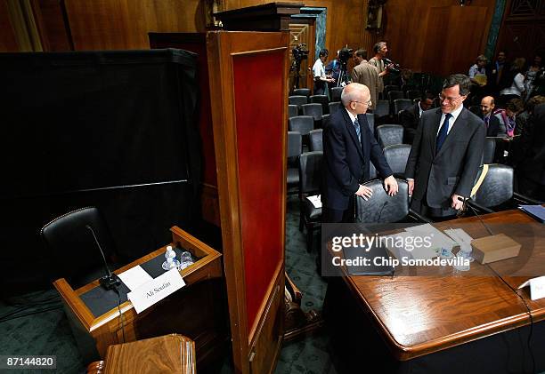 Former State Department lawyer Philip Zelikow talks with Georgetown University Professor of Law David Luban as they stand next to a desk set aside...