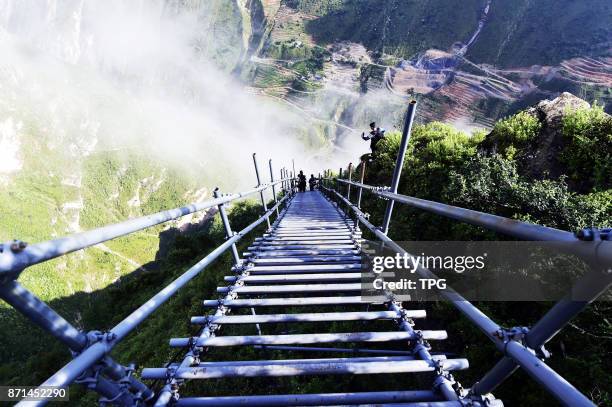 Iron stairs instead of rattan ladder was made to let villagers walk out the Cliff Village on 07th November, 2017 in Liangshan, Sichuan, China.