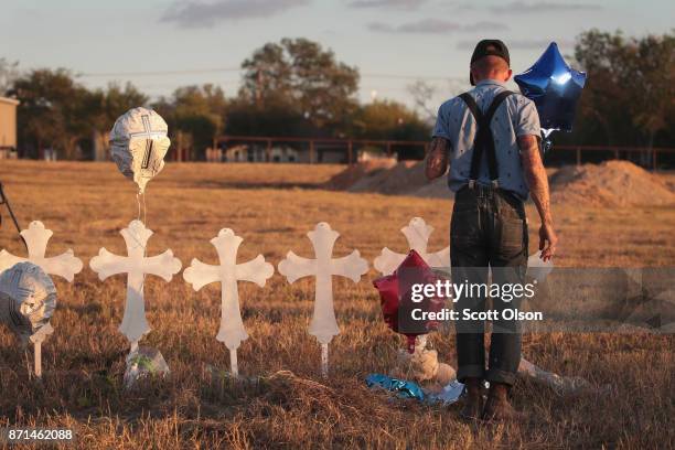 Derrick Bernaden of San Antonio, Texas visits a memorial where 26 crosses stand in a field on the edge of town to honor the 26 victims killed at the...