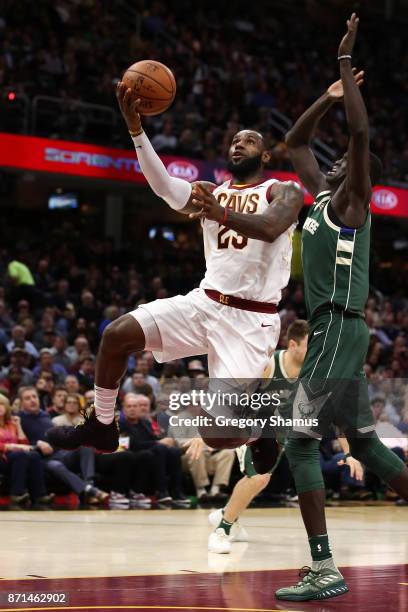 LeBron James of the Cleveland Cavaliers drives past Thon Maker of the Milwaukee Bucks during the second half at Quicken Loans Arena on November 7,...