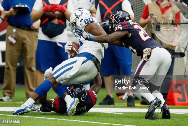 Chester Rogers of the Indianapolis Colts is tackled by Johnathan Joseph of the Houston Texans and Kareem Jackson at NRG Stadium on November 5, 2017...