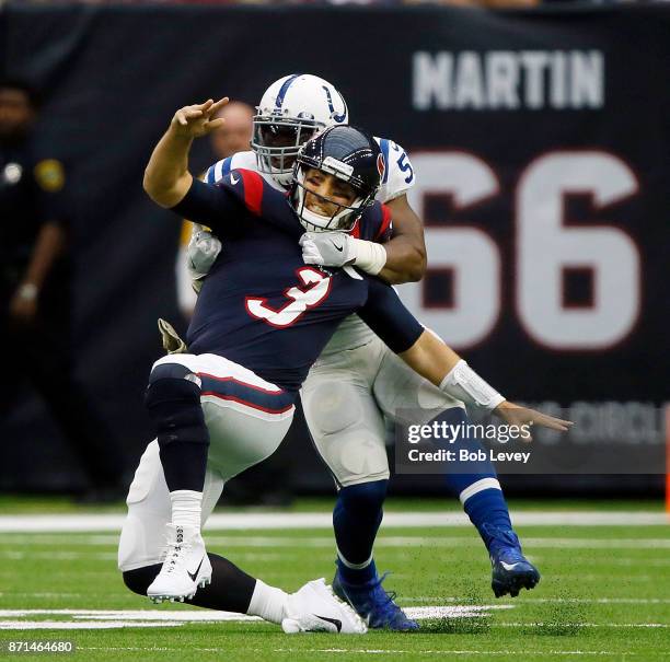 Tom Savage of the Houston Texans releases the ball as he his hit by Jonathan Bostic of the Indianapolis Colts at NRG Stadium on November 5, 2017 in...