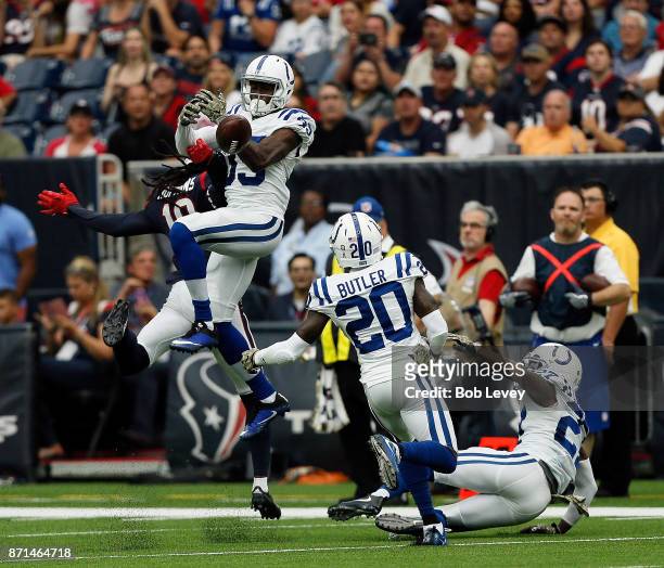 Pierre Desir of the Indianapolis Colts breaks up a pass intended for DeAndre Hopkins of the Houston Texans as Darius Butler and Nate Hairston look on...