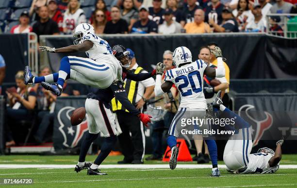 Pierre Desir of the Indianapolis Colts breaks up a pass intended for DeAndre Hopkins of the Houston Texans as Darius Butler and Nate Hairston look on...