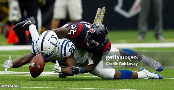 Chester Rogers of the Indianapolis Colts looses control of the ball as Kareem Jackson of the Houston Texans defends at NRG Stadium on November 5,...