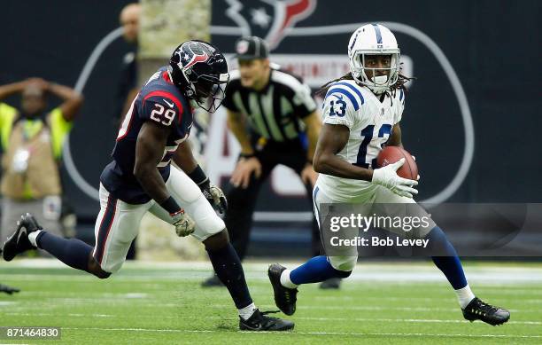 Hilton of the Indianapolis Colts runs with the ball after a catch as Andre Hal of the Houston Texans pursues at NRG Stadium on November 5, 2017 in...