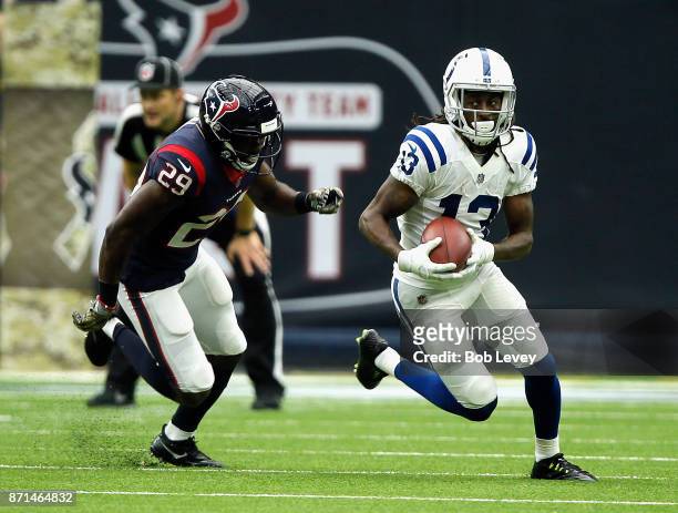Hilton of the Indianapolis Colts runs with the ball after a catch as Andre Hal of the Houston Texans pursues at NRG Stadium on November 5, 2017 in...