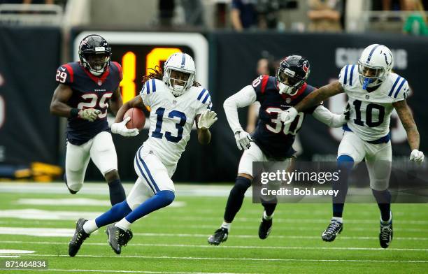 Hilton of the Indianapolis Colts runs with the ball after a catch as Andre Hal and Kevin Johnson of the Houston Texans pursues as Donte Moncrief...