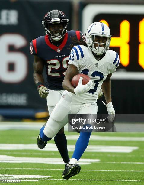 Hilton of the Indianapolis Colts runs with the ball after a catch as Andre Hal of the Houston Texans pursues at NRG Stadium on November 5, 2017 in...