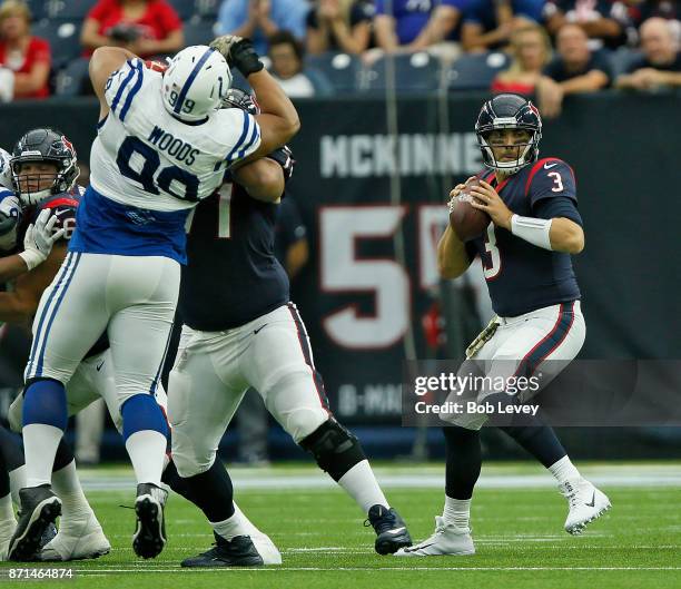 Tom Savage of the Houston Texans looks for a receiver as Xavier Su'a-Filo blocks Al Woods of the Indianapolis Colts at NRG Stadium on November 5,...