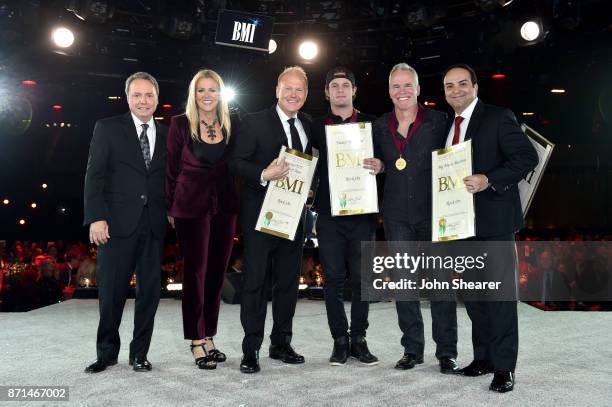 Winners of one of the 50 most performed country songs of the year for "Rock On" pose for a photo onstage during the 65th Annual BMI Country Awards at...