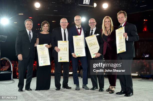 Winners of one of the 50 most performed country songs of the year for "Livin' the Dream" pose for a photo onstage during the 65th Annual BMI Country...