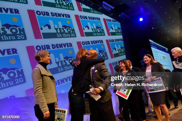 Denver Mayor Michael Hancock hugs Andrea Fulton, of the Denver Art Museum, after celebrates with bond supporters the passing of Denver's $937 million...