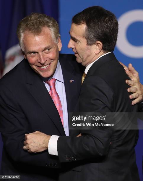 Virginia Gov.-elect Ralph Northam is embraced by current Gov. Terry McAuliffe at an election night rally November 7, 2017 in Fairfax, Virginia....