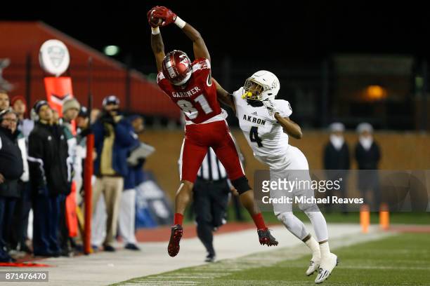 James Gardner of the Miami Ohio Redhawks makes a catch defended by Kyron Brown of the Akron Zips during the second half at Yager Stadium on November...