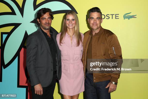 Global CEO Thierry Guibert , Gwyneth Paltrow, and Robbie Williams attend the celebration of the re-opening of the LACOSTE Rodeo Drive Boutique at...